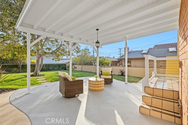 3 steps down to wonderful covered patio and large backyard! Mature Avocado tree bears fruit!