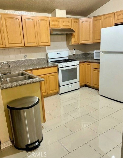 Simple & Beautiful. The gorgeous bullnose edge granite countertops and elegant 12x24 porcelain tiles are the 2 ingredients that make this kitchen!