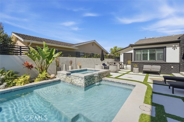 Spa, pool and concrete pavers interwoven with turf