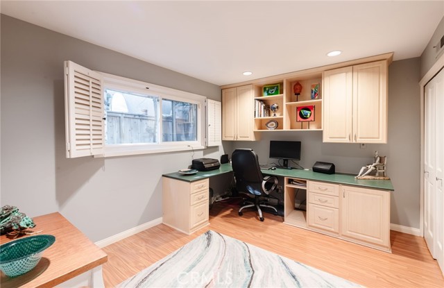 Main floor bedroom with custom built-in cabinetry for use as an office. Plenty of room for a bed too!