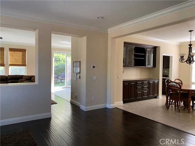 View from the front door: living room to the left, dining to the right, family room and kitchen through the walkway.
