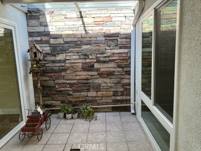 Pretty stacked stone accent wall is visible as you move through the home.