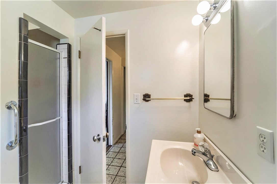 The lower level full bath adjoins the laundry room and the rear yard
