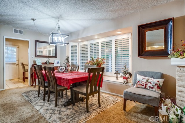 Elegant, light/bright Dining Room with newer windows and plantation shutters.