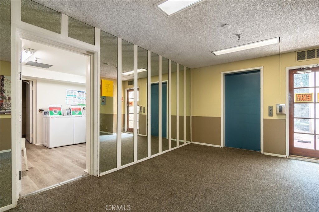 The elevator (blue door) leads to the community laundry