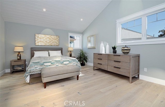 Master bedroom with vaulted ceiling, skylight & ceiling fan in front house