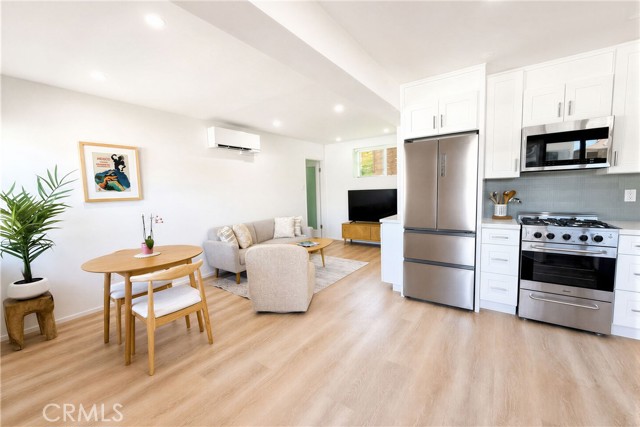 Turn-key lower unit offers a bright and beautiful layout with wide plank flooring, updated kitchen, recessed lights and an open concept design