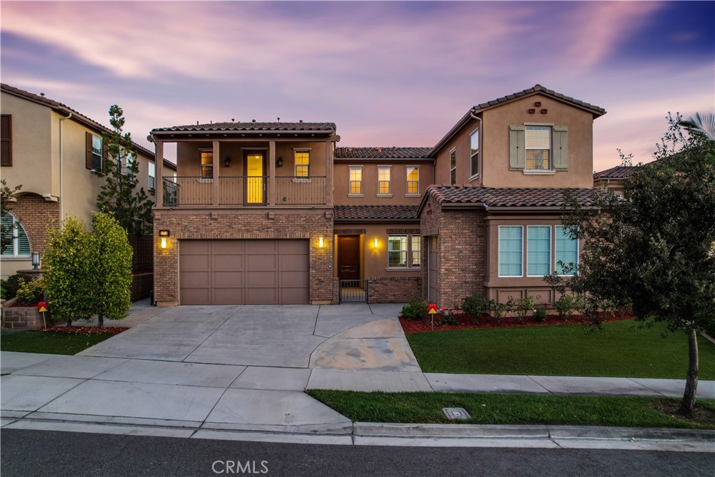 Welcome to this exquisite 5-bedroom, 5.5-bathroom residence nestled in the highly coveted Blackstone community of Brea. Built in 2013, this luxurious home boasts modern upgrades throughout, showcasing tasteful design and exceptional attention to detail. Come inside to find spacious living areas filled with natural light and stunning city views, including magical glimpses of Disneyland fireworks at night. On the first floor, you’ll find a convenient bedroom with an en suite bath, along with a stylish powder room for guests. A fully enclosed retreat offers the perfect space for relaxation, while the main kitchen opens seamlessly to a casual dining room and great room, complete with a cozy fireplace—ideal for gatherings. Culinary enthusiasts will also appreciate the separate chef’s kitchen, designed for more elaborate meal preparation. At the heart of the home is an impressive private elevator, featuring long windows that offer breathtaking scenic views as it glides from the ground level to the primary suite on the second floor, adding both elegance and convenience to your daily routine. The spacious primary suite opens to a private deck, shared with the loft, where you can soak in the serene surroundings. Upstairs, you’ll discover three additional bedrooms, a versatile loft, and a well-appointed laundry room. The Blackstone community enhances your lifestyle with a resort-style pool, a beautifully maintained park, and a security patrol for added peace of mind. With three garage spaces—one accommodating two vehicles and another for a single car—convenience is assured. Situated within the top-performing Brea Olinda School District and just minutes from the 57 freeway, this home offers the perfect blend of luxury, comfort, and community. Don’t miss your opportunity to own this remarkable property. Schedule your private tour today!