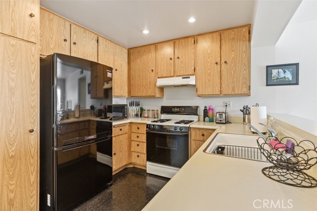 The fridge is a negotiable item - it looks like it belongs in this kitchen.