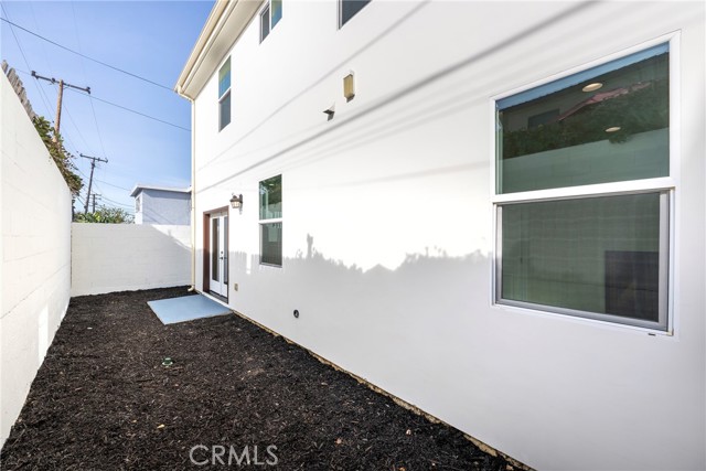 Side yard patio has French doors to interior dining area.