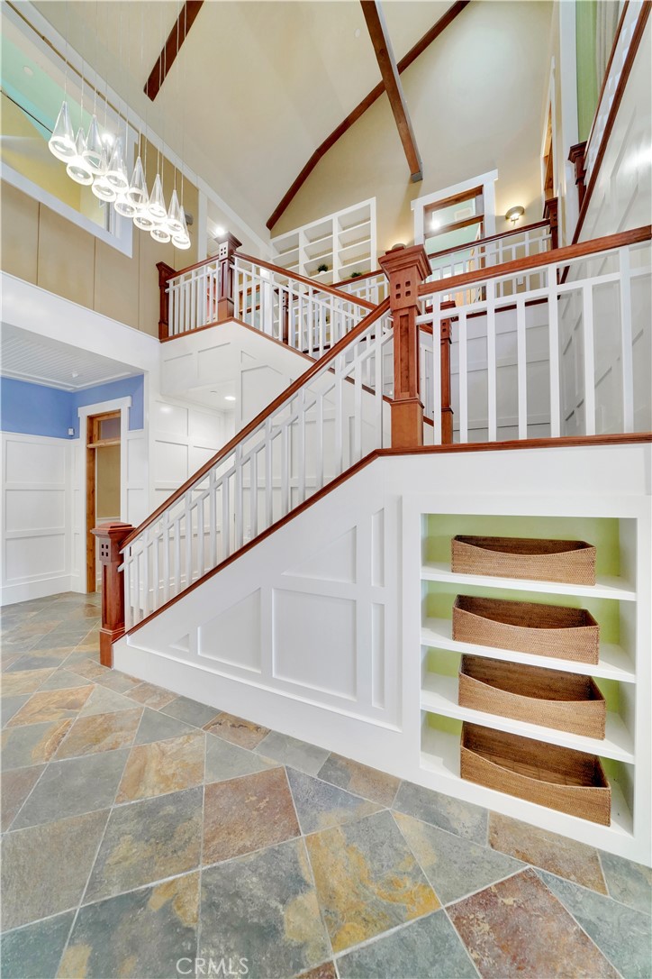 built in shelving in entry hall, gorgeous stone flooring
