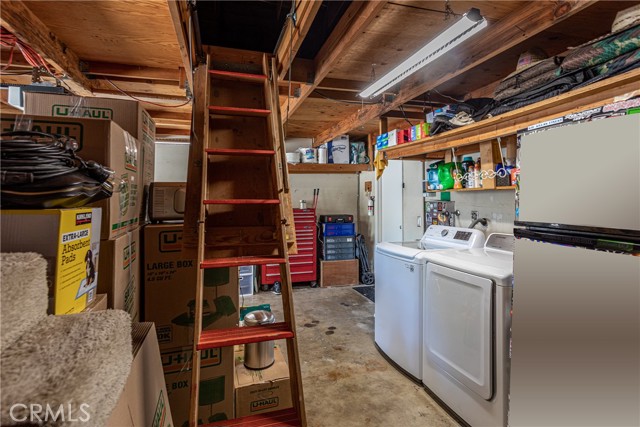 Additional storage in garage accessible by this ladder carefully tucked away above!