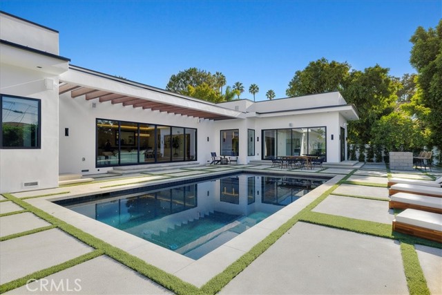 Elegant Modern Living in Encino’s Finest Location!

Nestled on a quiet cul-de-sac south of Ventura Blvd, this stunning 5-bedroom, 5.5-bath single-story home offers 3,818 sq ft of luxurious space, plus a fully finished 512 sq ft garage, all set on a generous 17,000 sq ft lot. 

High 10-foot ceilings and Western sliding doors create an open, airy flow between indoor and outdoor spaces, leading to a beautifully landscaped yard with a sparkling pool—perfect for relaxation or entertaining. 

Inside, enjoy the warmth of engineered wood floors, a cozy gas fireplace, and a gourmet kitchen with MIELE appliances and custom European cabinetry. The master suite is a private oasis with a spa-like bathroom and his-and-her closets, while every bedroom provides ensuite baths for privacy and comfort. 

Located close to popular restaurants, shops, and essentials, this home is a rare gem offering modern elegance and a prime Encino lifestyle.

Don’t miss the chance to make this extraordinary property yours!