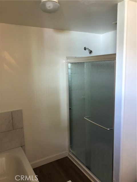 Back unit bathroom showing a separate shower and tub