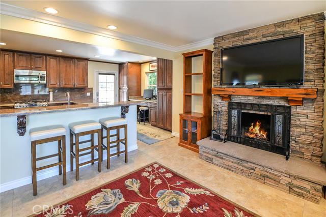 fireplace with kitchen and barstools