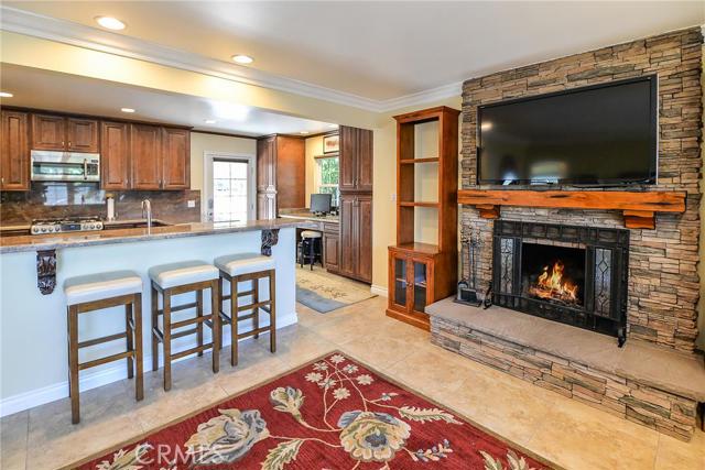 fireplace with kitchen and barstools