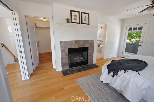 Primary Bedroom walk in closet and fireplace.