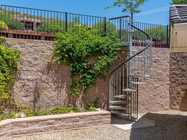 Spiral staircase leading to upper lot. Not visible - more conventional steps also leading to upper lot