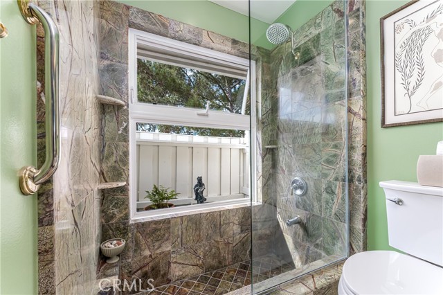 Secondary bathroom has access from both the hallway and second bedroom. This bath can easily accomodate a dual sink vanity.