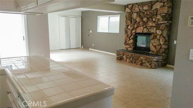 This is from the kitchen entry through the family room showing the fireplace and in the center, the doors to the front units laundry.