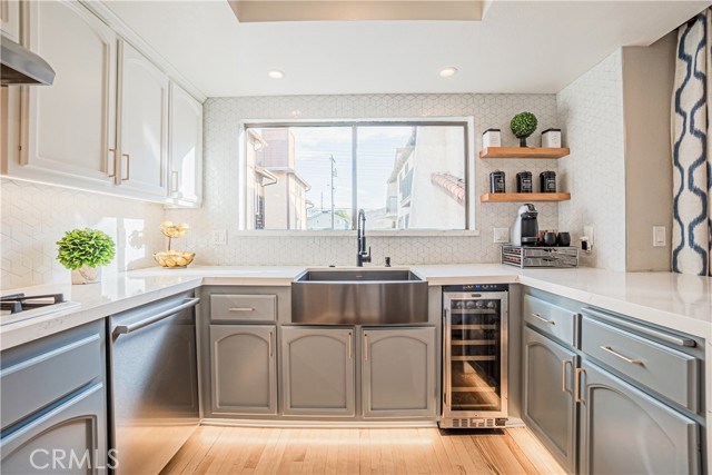 The elegantly remodeled kitchen, stunning quartz countertops, stainless steel appliances with dual ovens, and ample counter space and storage.