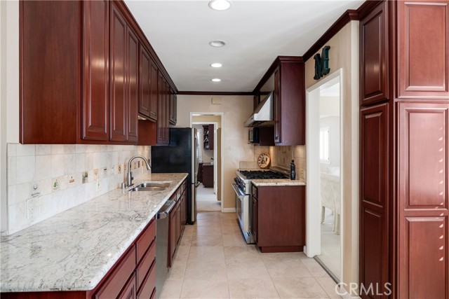 Galley kitchen cabinets on the right are a broom closet and a pantry