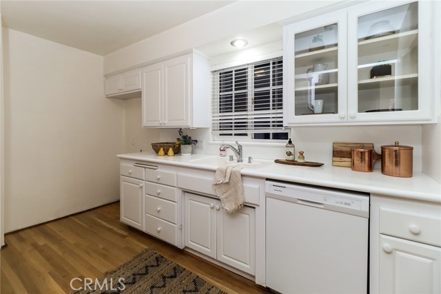 Glass doors in the cabinets and Corian counters and sink.