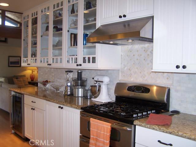 Beautifully Remodeled in 2009. Maytag Double Oven with Stainless Range Hood, Marvel Wine Fridge (48 Bottle), Marble Back-Splash, Granite Counter Tops, Bead Board Cabinetry, GE Fridge (not pictured).