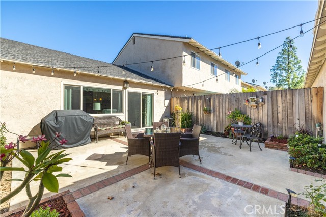 Backyard with concrete and brick ribbon accent.