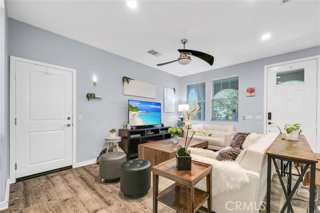 Family room with the front door on the right and on the left is the door leading to the garage.