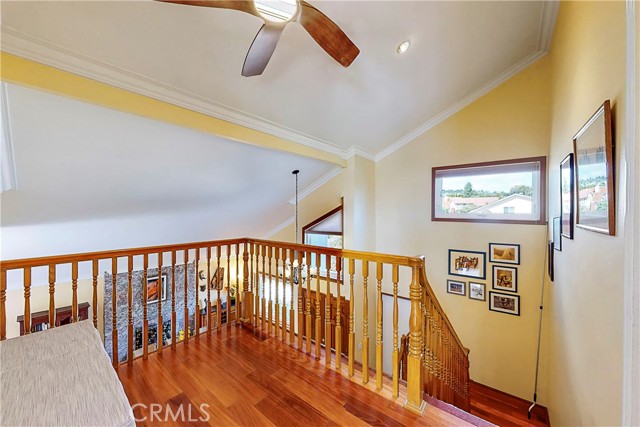 Loft area with ceiling fan.