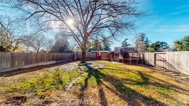 yard goes to fence behind red building