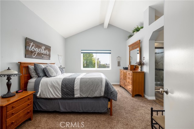 Master bedroom with vaulted ceiling and views.