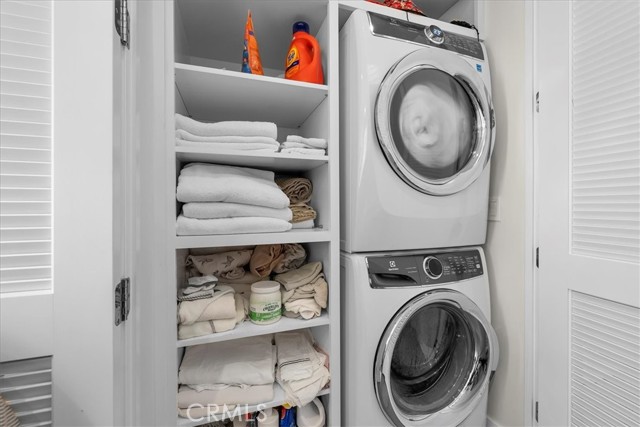 In-closet stacked laundry and additional linen storage
