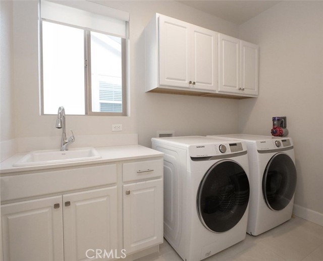 Full size Laundry room w/ window, sink, & storage. Located Upstairs.