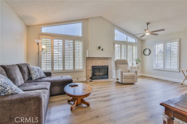 Main living room and dining area with LVP floors, vaulted ceilings, clerestory windows, lots of light