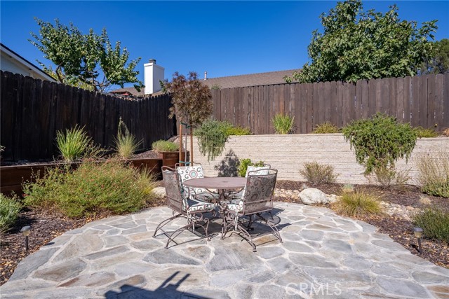 Elegant flagstone patio is a pleasant spot to unwind and enjoy the backyard.