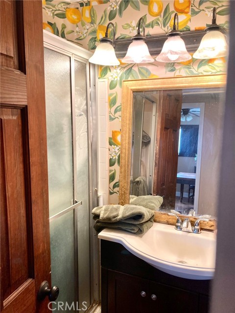 Elegant 3/4 bathroom; with space for a stacked washer/dryer.