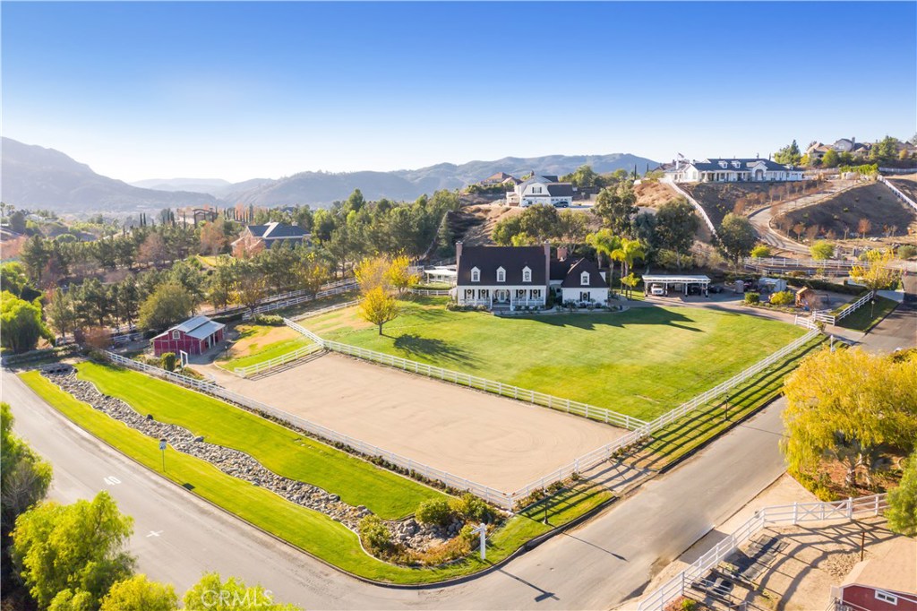 43675 El Faro Place Temecula, California Luxury Country living located in the most desirable area of Santiago Ranchos in Temecula. Classic Colonial 5 bed/4.5 bath, plus office/playroom with kitchenette sits a top this uniquely exquisite & picturesque 2.46 acre lot. With over 5,300 sq ft, this Stunning Estate was designed by renowned William Poole Architect. The Downstairs floor plan includes the Master bedroom Suite with fireplace, laundry room, Gourmet Kitchen with great room & fireplace, formal living with fireplace, informal family/office with fireplace, & formal dining room. All remaining bedrooms upstairs, with built in 'secret' rooms. This is an equestrian lovers Dream with full horse facilities, tack room, barn with indoor/outdoor grazing stalls, and riding arena. The Estate was completely remodeled in 2006 to include: new plumbing, natural gas conversion, electrical upgrade, new roof in 2009, private street lights, artificial turf, RV hook ups, Swarovski Chandelier at entrance, and much more. The backyard was completely rebuilt in 2020 & is an private oasis to include pebble tec salt water pool/spa & rock water slide. Close to Wine Country, shopping, schools, Pechanga Resort, and Community rose garden. This Beautiful Premiere Estate is a must see!