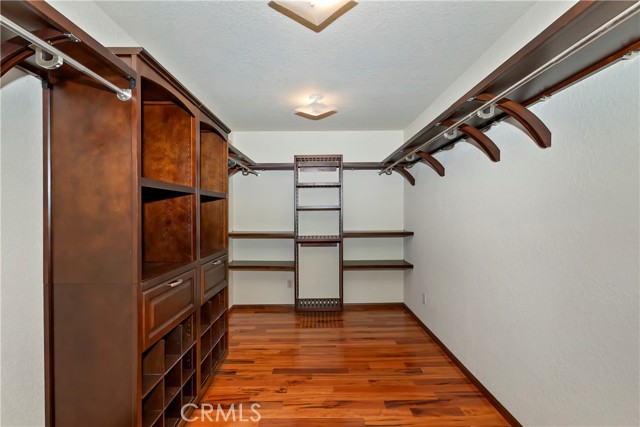 Walk in 7x12 foot closet with custom built cabinets.