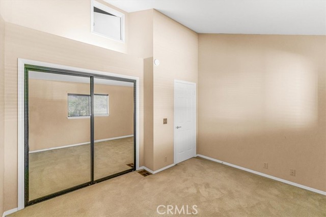 Secondary closet with large mirrored closet doors