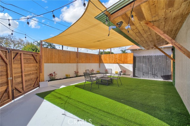 Back patio with artificial turf and double wide gate