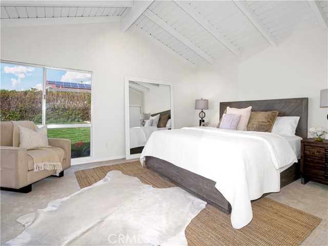 Master Bedroom with high ceiling and view of the plush rear yard.