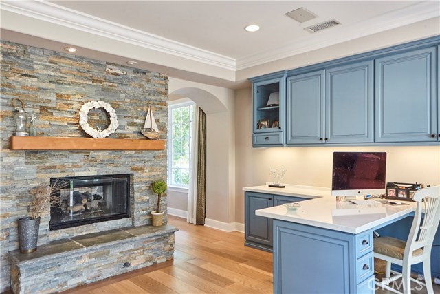 View of fireplace and archway to living room