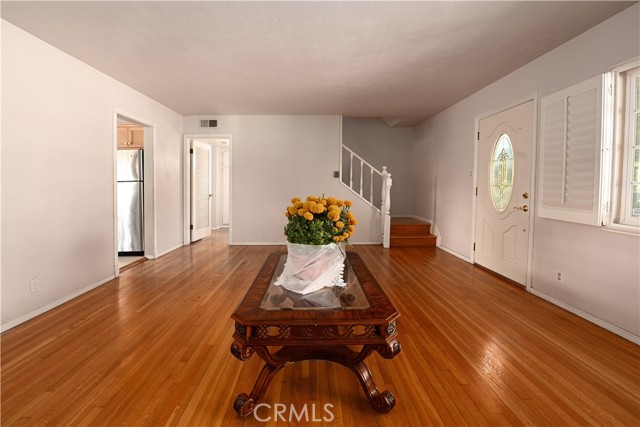 AMPLE LIVING ROOM WITH WOOD FLOORS