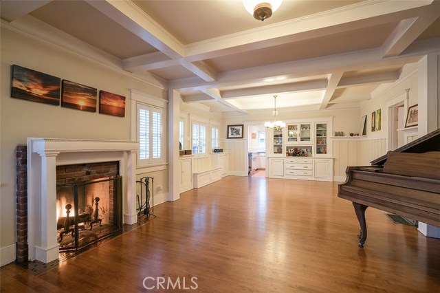 Living room with gas or wood fireplace to the dining room and kitchen. The built in cabinetry is envisioned by the current owners to be moved to the wall on the right. This would then open the kitchen wall the kitchen to the dining and living room.