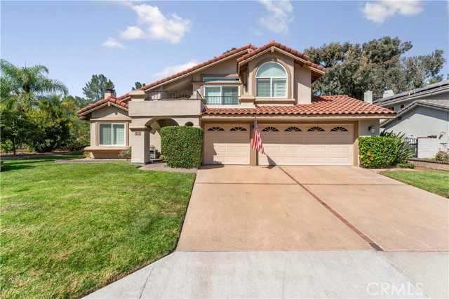 Beautiful home with pride of ownership. Balcony from Primary bedroom, three car garage and space to park three in the driveway. Tile roof.Citrus tree in front. Hibiscus plants by garage.