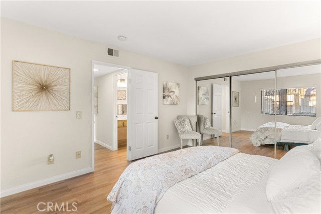 Primary bedroom with paneled doors, and triple mirrored wardrobe doors. This room is spacious.