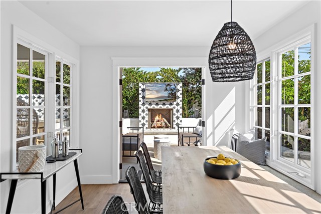 French doors in dining area open backyard and fireplace.