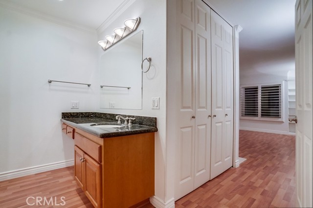 Vanity with make up area in Master Suite. Doors open to closet.